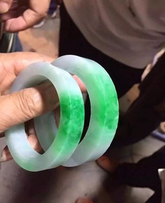 一条色带贯穿翡翠原石,围观者高喊"要的就是它"!